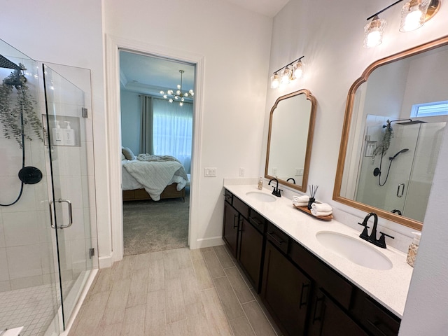 9865 SW Meridian Way, Stuart, FL 34997 - ensuite bathroom featuring double vanity, a stall shower, and a chandelier