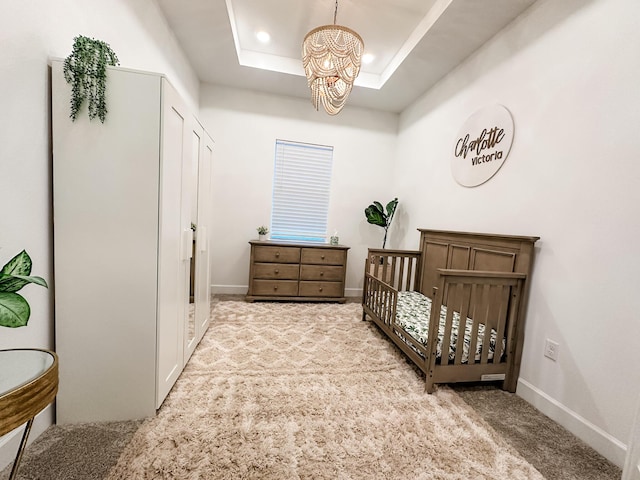 9865 SW Meridian Way, Stuart, FL 34997 - bedroom featuring a chandelier, carpet, a crib, and a raised ceiling