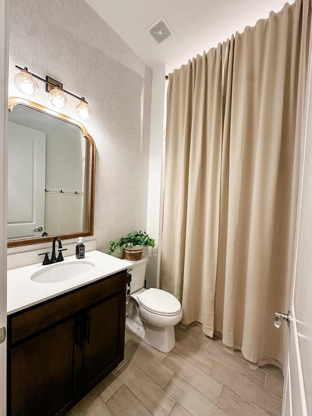 9865 SW Meridian Way, Stuart, FL 34997 - full bathroom featuring wood finish floors, vanity, wallpapered walls, and a shower with curtain