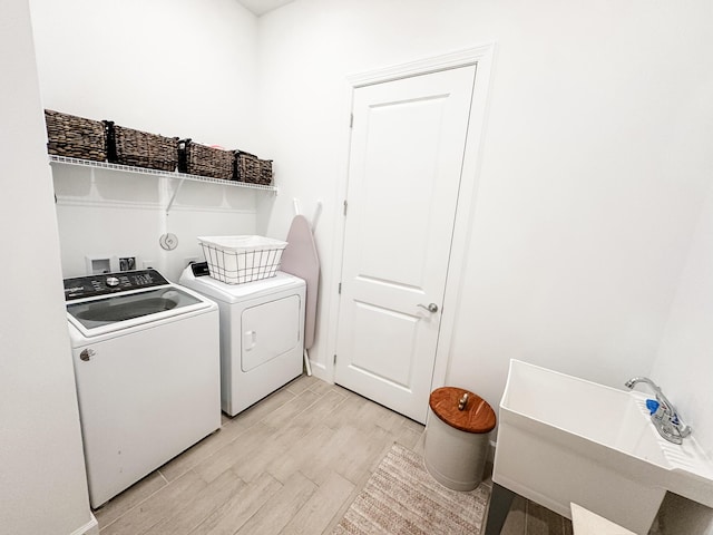 9865 SW Meridian Way, Stuart, FL 34997 - washroom featuring washer and dryer and light wood-style floors