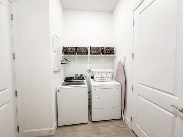 9865 SW Meridian Way, Stuart, FL 34997 - laundry area featuring washing machine and dryer and baseboards