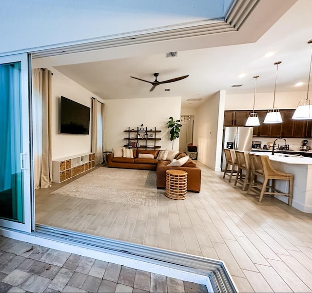 9865 SW Meridian Way, Stuart, FL 34997 - living area with light wood-style floors and ceiling fan