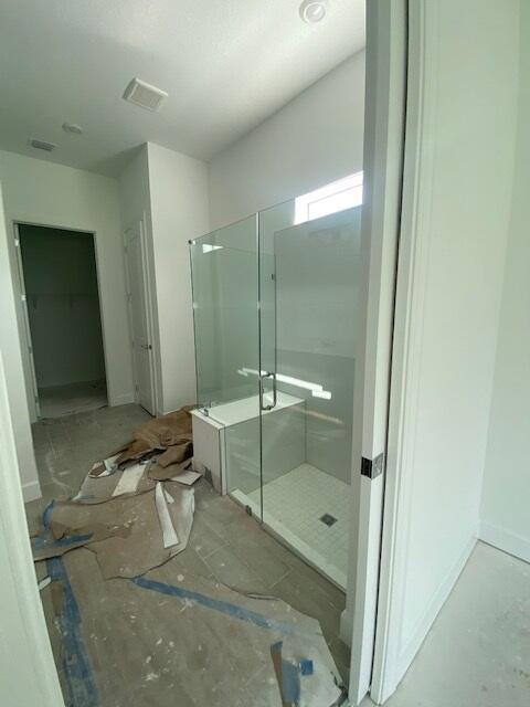 9865 SW Meridian Way, Stuart, FL 34997 - full bathroom with a shower stall and baseboards