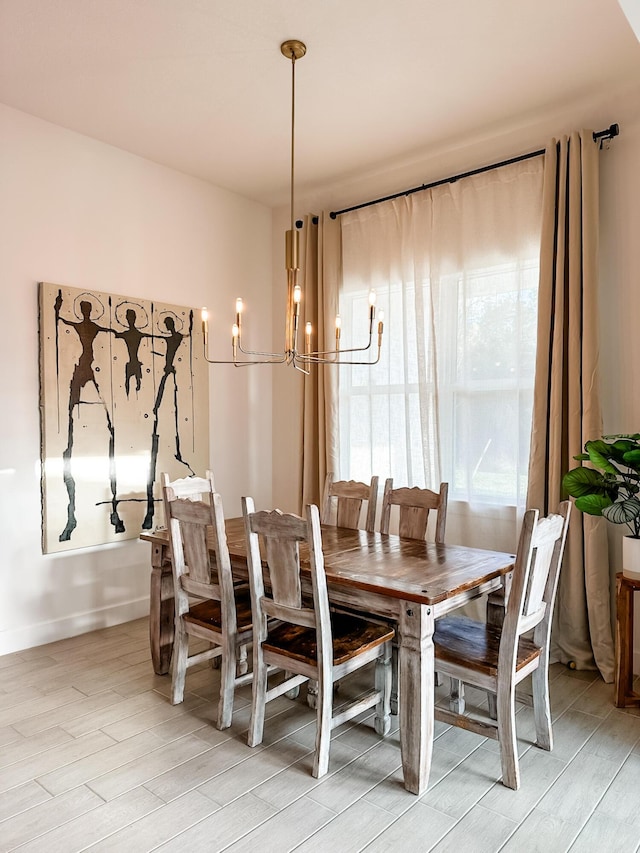 9865 SW Meridian Way, Stuart, FL 34997 - dining space featuring light wood finished floors and a chandelier