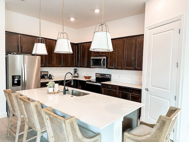 9865 SW Meridian Way, Stuart, FL 34997 - kitchen featuring appliances with stainless steel finishes, dark brown cabinetry, pendant lighting, and recessed lighting