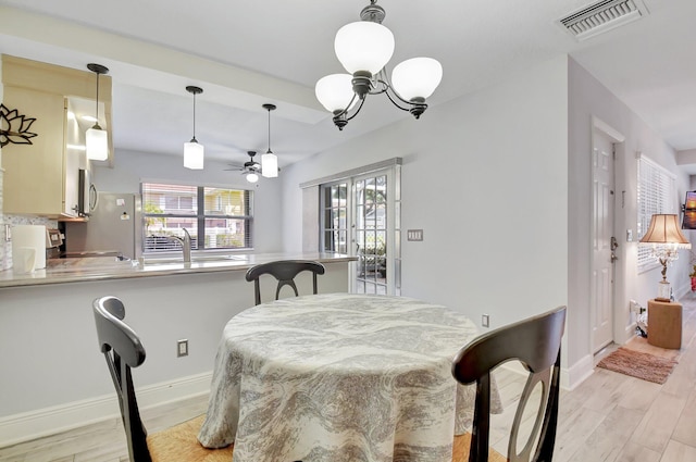 5201 Wheatley Ct, Boynton Beach, FL 33436 - dining space featuring ceiling fan, light wood-style flooring, a chandelier, and baseboards