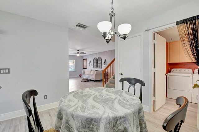 5201 Wheatley Ct, Boynton Beach, FL 33436 - dining area featuring washer and clothes dryer, a chandelier, light wood-type flooring, ceiling fan, and stairway