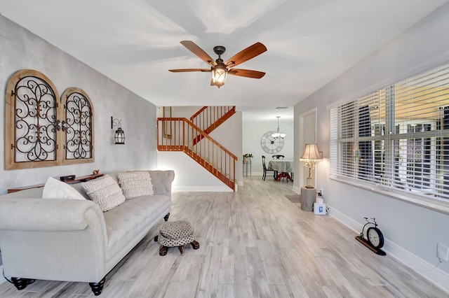 5201 Wheatley Ct, Boynton Beach, FL 33436 - living area with stairway, a ceiling fan, wood finished floors, a chandelier, and baseboards
