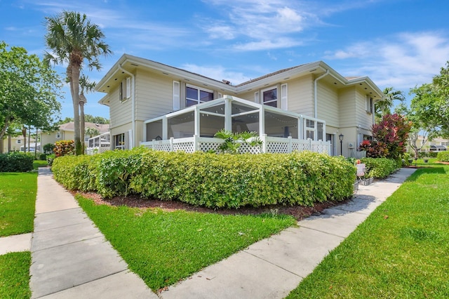 5201 Wheatley Ct, Boynton Beach, FL 33436 - view of side of home featuring a lawn and a sunroom