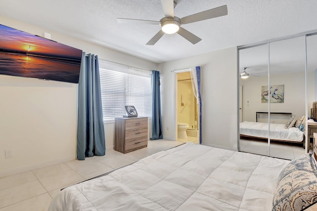 5201 Wheatley Ct, Boynton Beach, FL 33436 - bedroom featuring light tile patterned flooring, a textured ceiling, ensuite bathroom, ceiling fan, and a closet