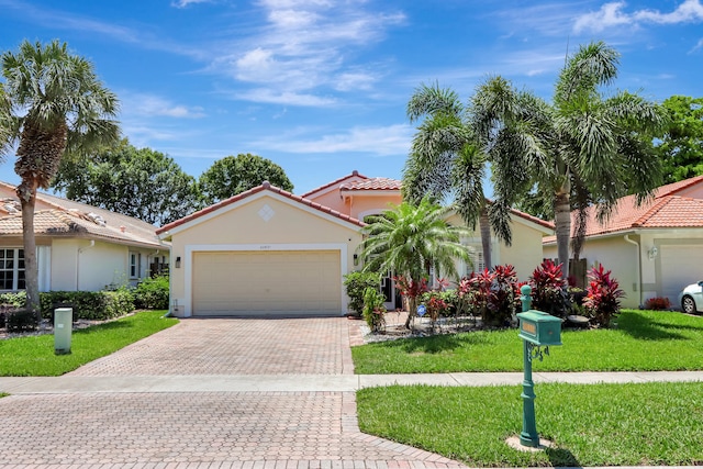 22831 Royal Crown Ter, Boca Raton, FL 33433 - view of front of property featuring stucco siding, decorative driveway, a garage, and a front yard