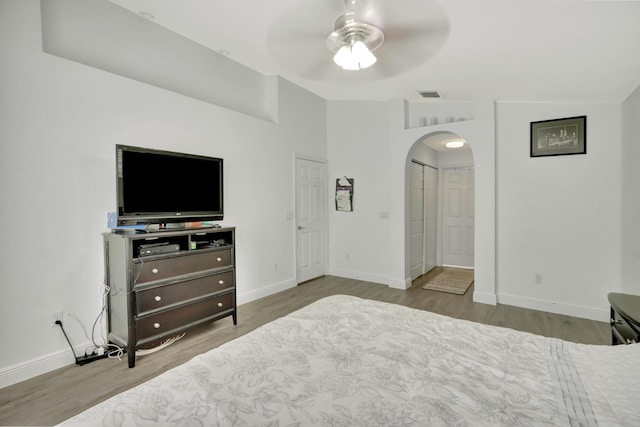 22831 Royal Crown Ter, Boca Raton, FL 33433 - bedroom with arched walkways, wood finished floors, baseboards, and ceiling fan