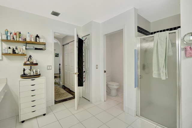 22831 Royal Crown Ter, Boca Raton, FL 33433 - bathroom with a stall shower, toilet, and tile patterned floors