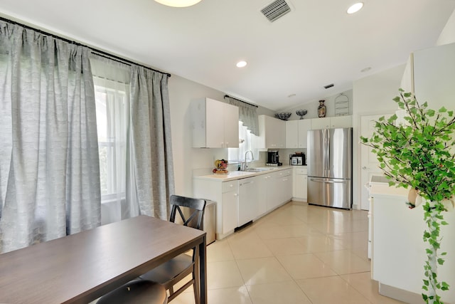 22831 Royal Crown Ter, Boca Raton, FL 33433 - kitchen featuring freestanding refrigerator, dishwasher, vaulted ceiling, light countertops, and a sink
