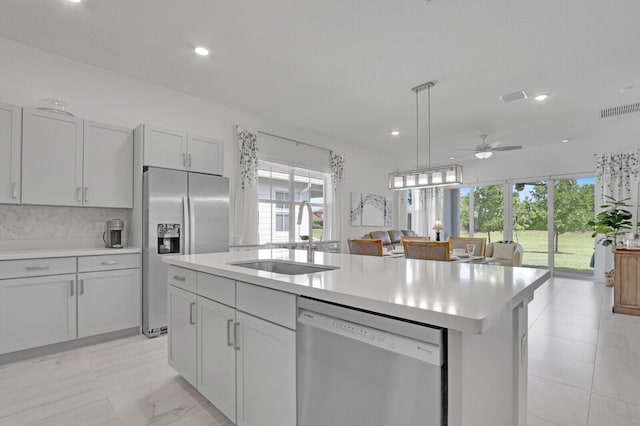 19579 Weathervane Way, The Acreage, FL 33470 - kitchen with a sink, appliances with stainless steel finishes, light countertops, open floor plan, and healthy amount of natural light