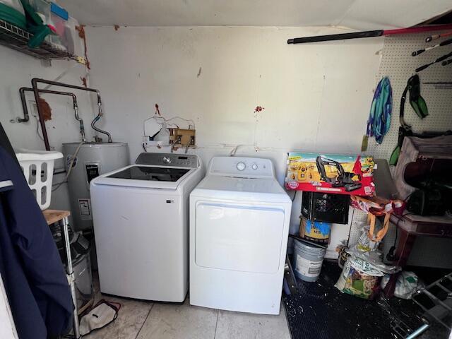 4928 Jefferson Rd, Delray Beach, FL 33445 - clothes washing area with washer and clothes dryer and electric water heater