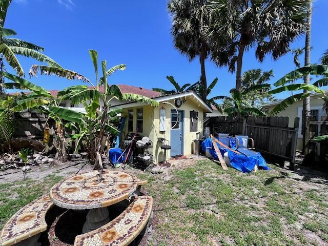 4928 Jefferson Rd, Delray Beach, FL 33445 - rear view of property with fence and stucco siding