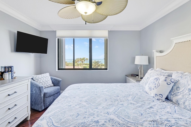 bedroom with crown molding, dark wood finished floors, and ceiling fan