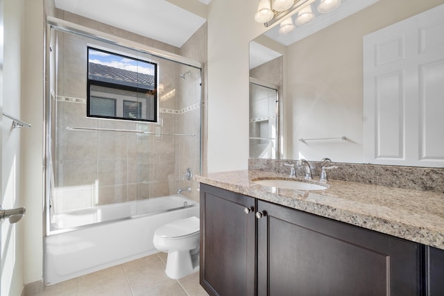 bathroom featuring toilet, tile patterned floors, shower / bath combination with glass door, and vanity