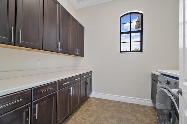 laundry area with washer / clothes dryer, cabinet space, ornamental molding, baseboards, and tile patterned flooring