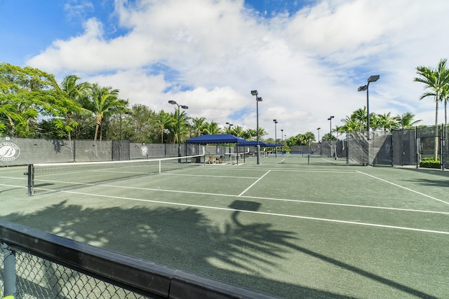 view of tennis court featuring fence