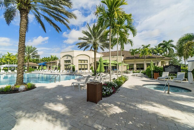 community pool with a community hot tub and a patio