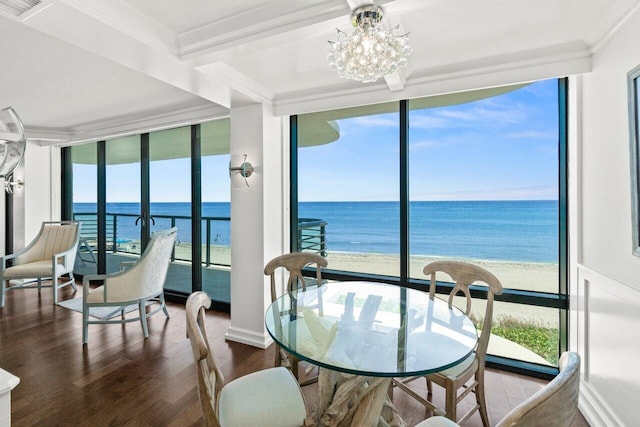 250 S Ocean Blvd Unit 2H, Boca Raton, FL 33432 - dining area with floor to ceiling windows, view of water and beach, wood finished floors, a chandelier, and ornamental molding