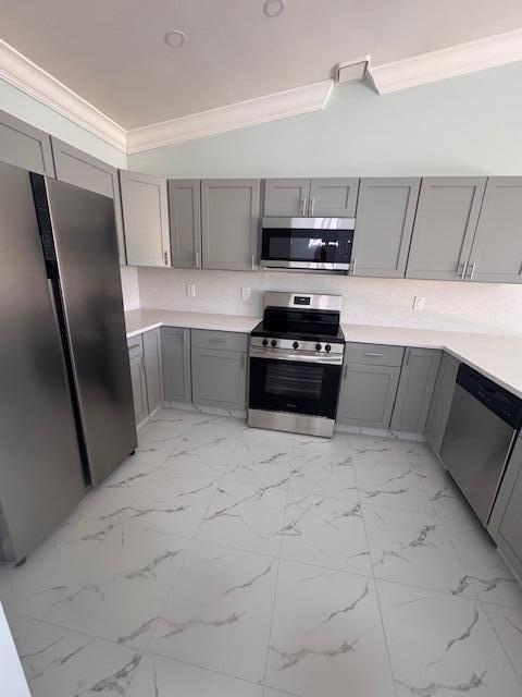 21 Walcott Dr, Boynton Beach, FL 33426 - kitchen with stainless steel appliances, gray cabinets, ornamental molding, light countertops, and light marble finish floors