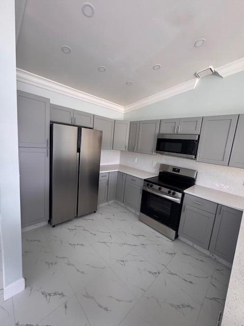 21 Walcott Dr, Boynton Beach, FL 33426 - kitchen featuring appliances with stainless steel finishes, gray cabinetry, light countertops, crown molding, and recessed lighting