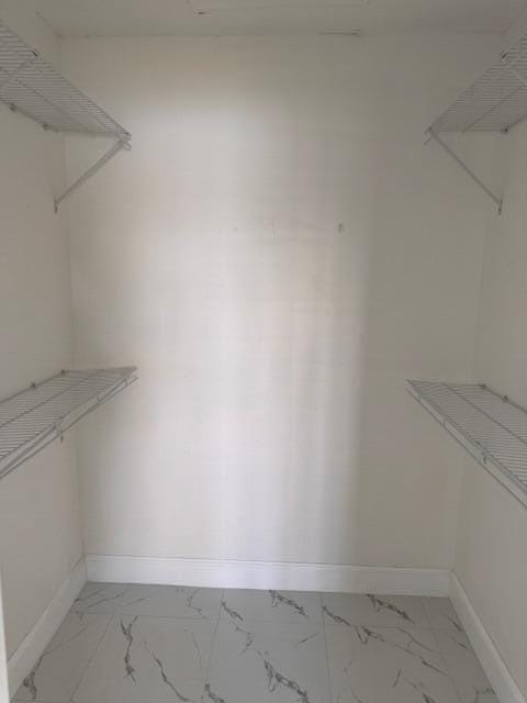 21 Walcott Dr, Boynton Beach, FL 33426 - spacious closet with light marble finish floors