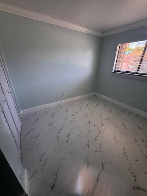 21 Walcott Dr, Boynton Beach, FL 33426 - unfurnished room with crown molding, marble finish floors, and baseboards