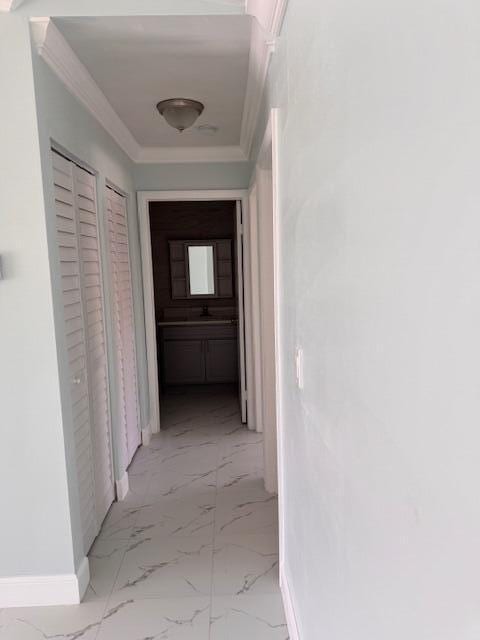 21 Walcott Dr, Boynton Beach, FL 33426 - hall featuring light marble finish flooring, baseboards, crown molding, and a sink