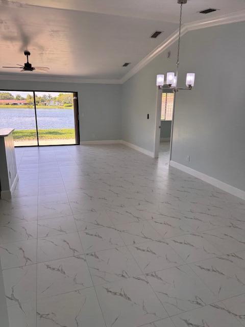 21 Walcott Dr, Boynton Beach, FL 33426 - spare room with crown molding, plenty of natural light, baseboards, and a chandelier