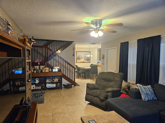 24 Bedford Ct Unit A, Royal Palm Beach, FL 33411 - living area featuring light tile patterned flooring, ceiling fan, stairs, and a textured ceiling