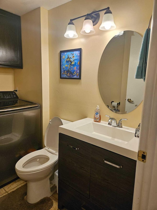 24 Bedford Ct Unit A, Royal Palm Beach, FL 33411 - bathroom with washer / clothes dryer, vanity, and toilet