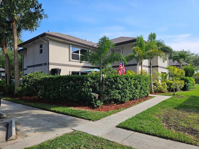 24 Bedford Ct Unit A, Royal Palm Beach, FL 33411 - view of side of property featuring stucco siding