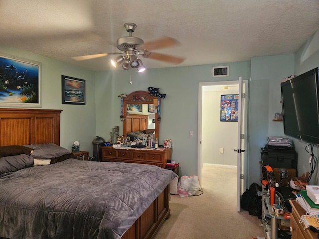 24 Bedford Ct Unit A, Royal Palm Beach, FL 33411 - bedroom featuring light colored carpet, a textured ceiling, and ceiling fan