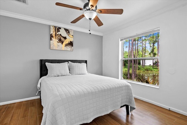16931 N 78th Rd N, The Acreage, FL 33470 - bedroom with ornamental molding, wood finished floors, baseboards, and ceiling fan