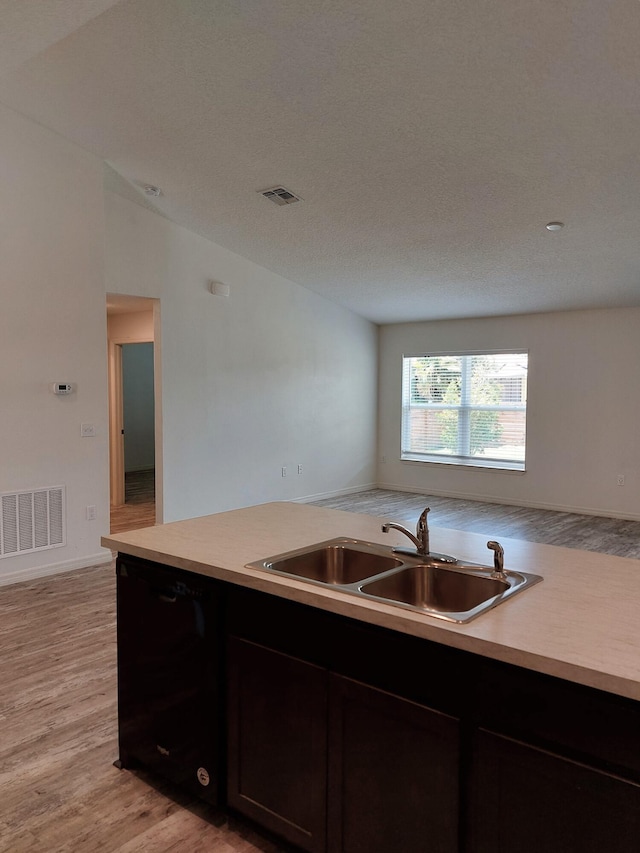 1614 SW Sylvester Ln, Port Saint Lucie, FL 34984 - kitchen with a sink, dishwasher, light countertops, and light wood-style flooring