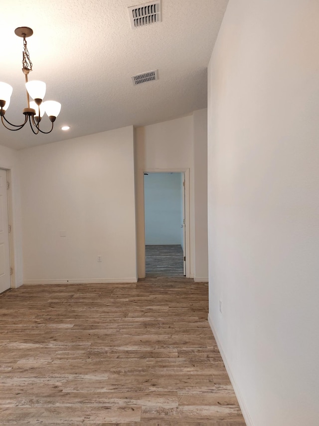 1614 SW Sylvester Ln, Port Saint Lucie, FL 34984 - unfurnished room featuring a chandelier, light wood-style flooring, baseboards, a textured ceiling, and recessed lighting