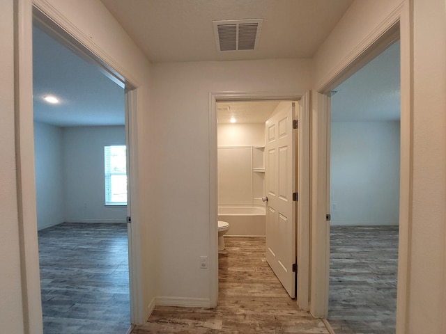 1614 SW Sylvester Ln, Port Saint Lucie, FL 34984 - hallway with wood finished floors and baseboards
