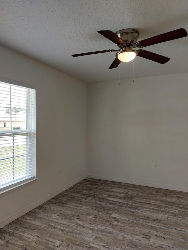 1614 SW Sylvester Ln, Port Saint Lucie, FL 34984 - unfurnished room featuring wood finished floors, ceiling fan, a textured ceiling, and baseboards