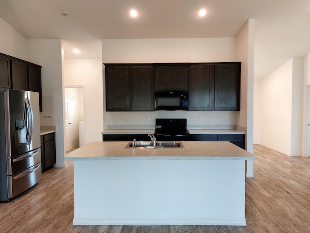 1614 SW Sylvester Ln, Port Saint Lucie, FL 34984 - kitchen with black appliances, a sink, light countertops, light wood-style floors, and recessed lighting