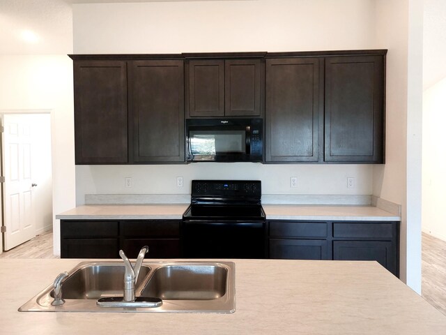 1614 SW Sylvester Ln, Port Saint Lucie, FL 34984 - kitchen with black appliances, a sink, light countertops, and dark brown cabinetry