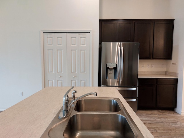 1614 SW Sylvester Ln, Port Saint Lucie, FL 34984 - kitchen with stainless steel fridge, a sink, light countertops, and dark brown cabinets