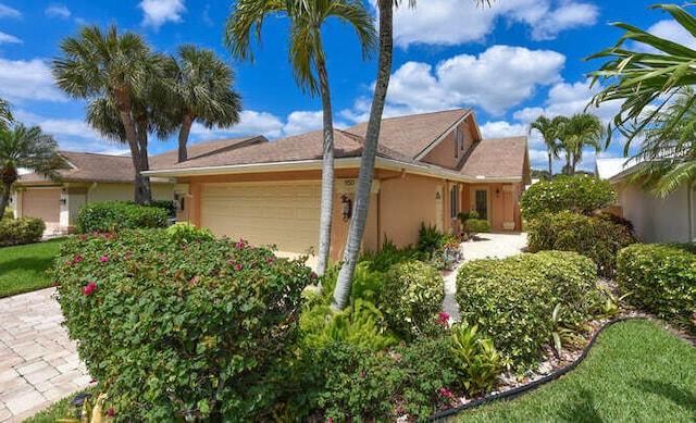 150 Beach Summit Ct, Jupiter, FL 33477 - view of side of property featuring an attached garage and stucco siding