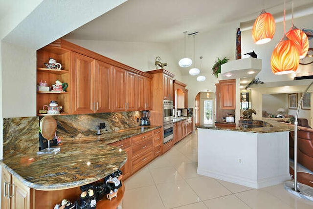150 Beach Summit Ct, Jupiter, FL 33477 - kitchen featuring open shelves, arched walkways, double oven, a peninsula, and pendant lighting