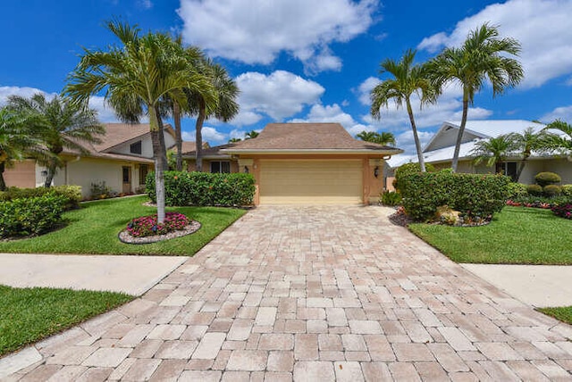 150 Beach Summit Ct, Jupiter, FL 33477 - ranch-style house with decorative driveway, a garage, and a front lawn