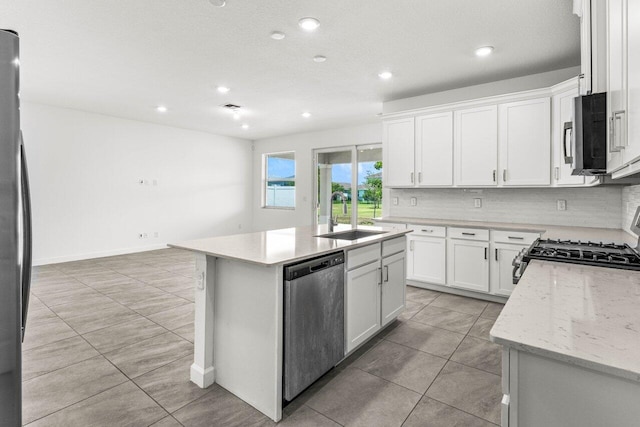 19659 Rugged Trunk Trl, Loxahatchee, FL 33470 - kitchen with stainless steel appliances, a sink, recessed lighting, a kitchen island with sink, and white cabinets