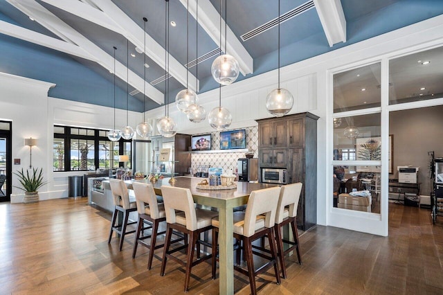 19659 Rugged Trunk Trl, Loxahatchee, FL 33470 - dining room with a towering ceiling, dark wood-style floors, beamed ceiling, and recessed lighting